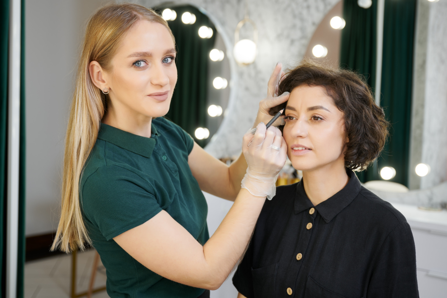 eyebrow specialist with client in chair
